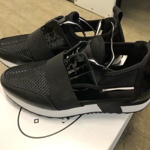 Steve Madden black sneaker style shoe with sides out black white bottom